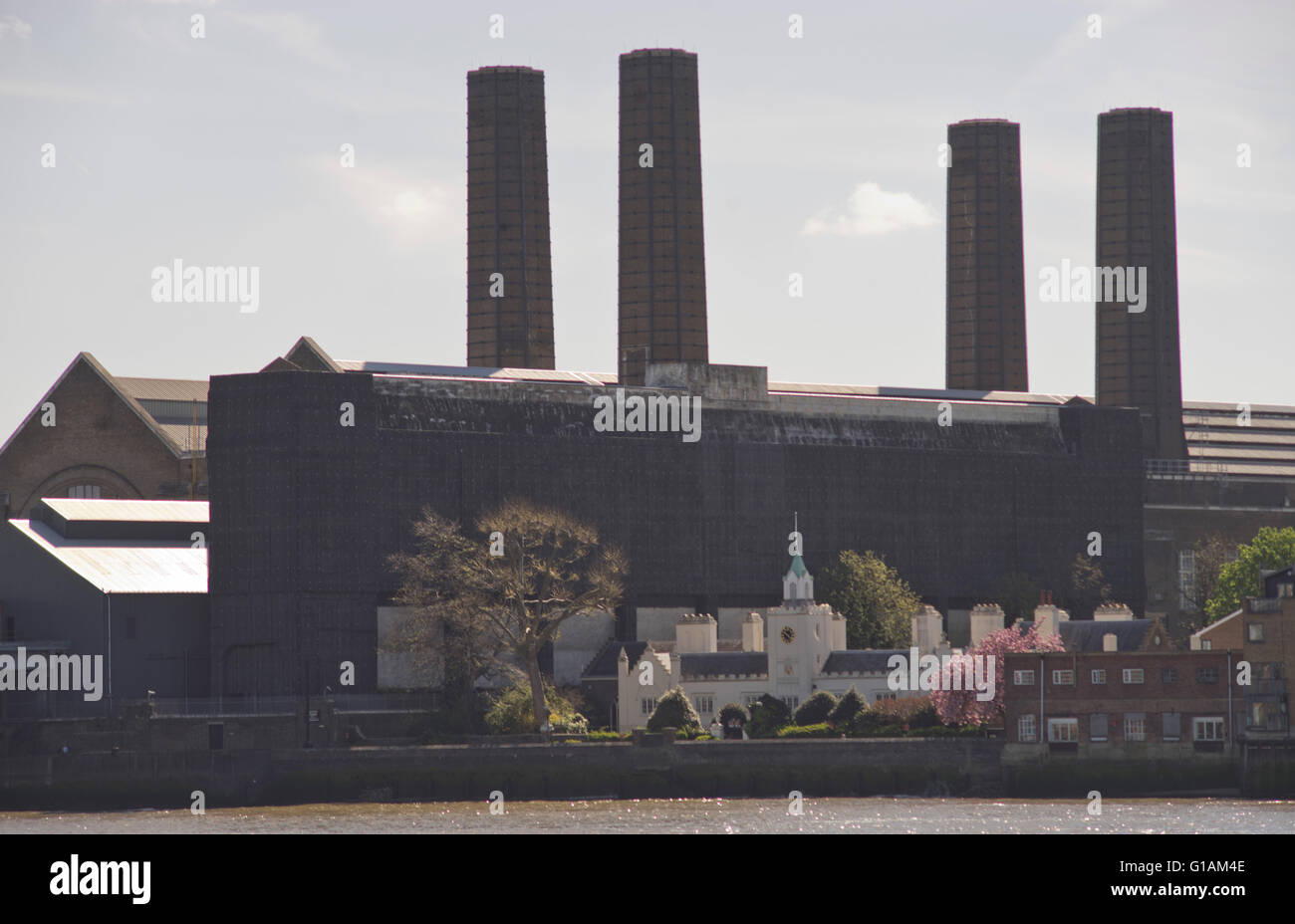 View of Trinity Hospital  almshouses for elderly people by river Thames old power station in Greenwich. London, UK Stock Photo