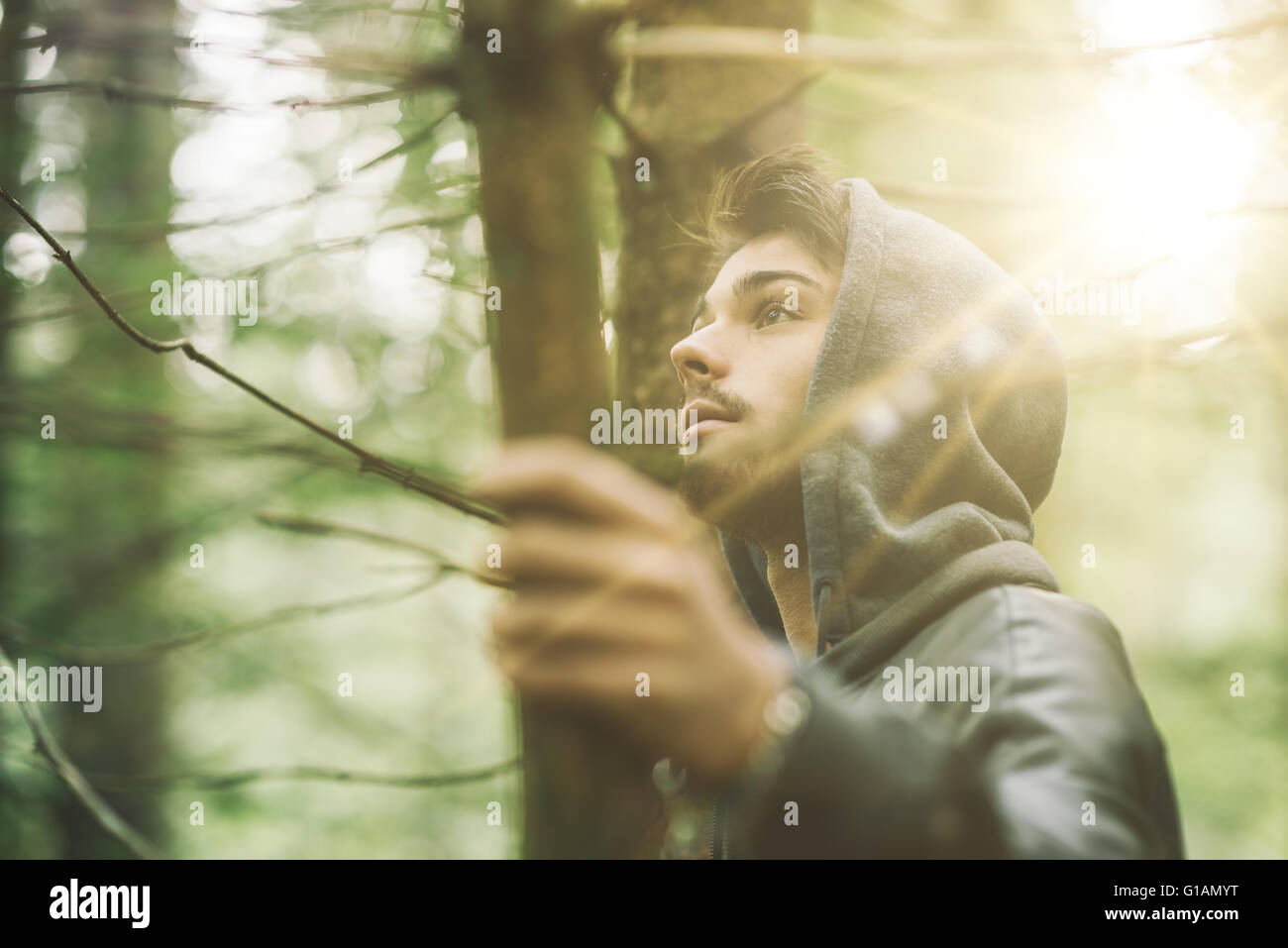 Hooded guy in the woods exploring nature, individuality and freedom concept Stock Photo