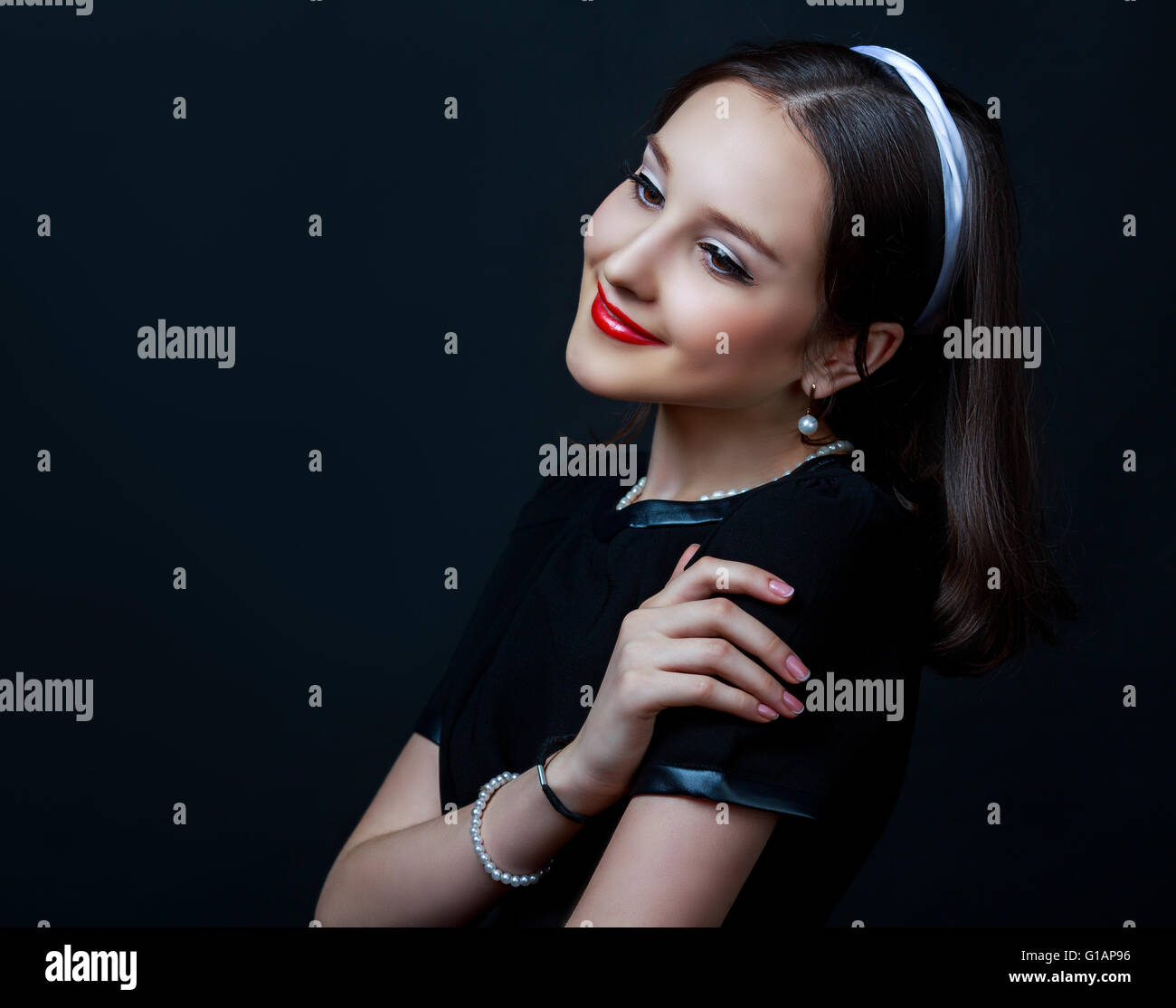 beautiful woman with retro makeup and clothes, against dark studio  background Stock Photo - Alamy