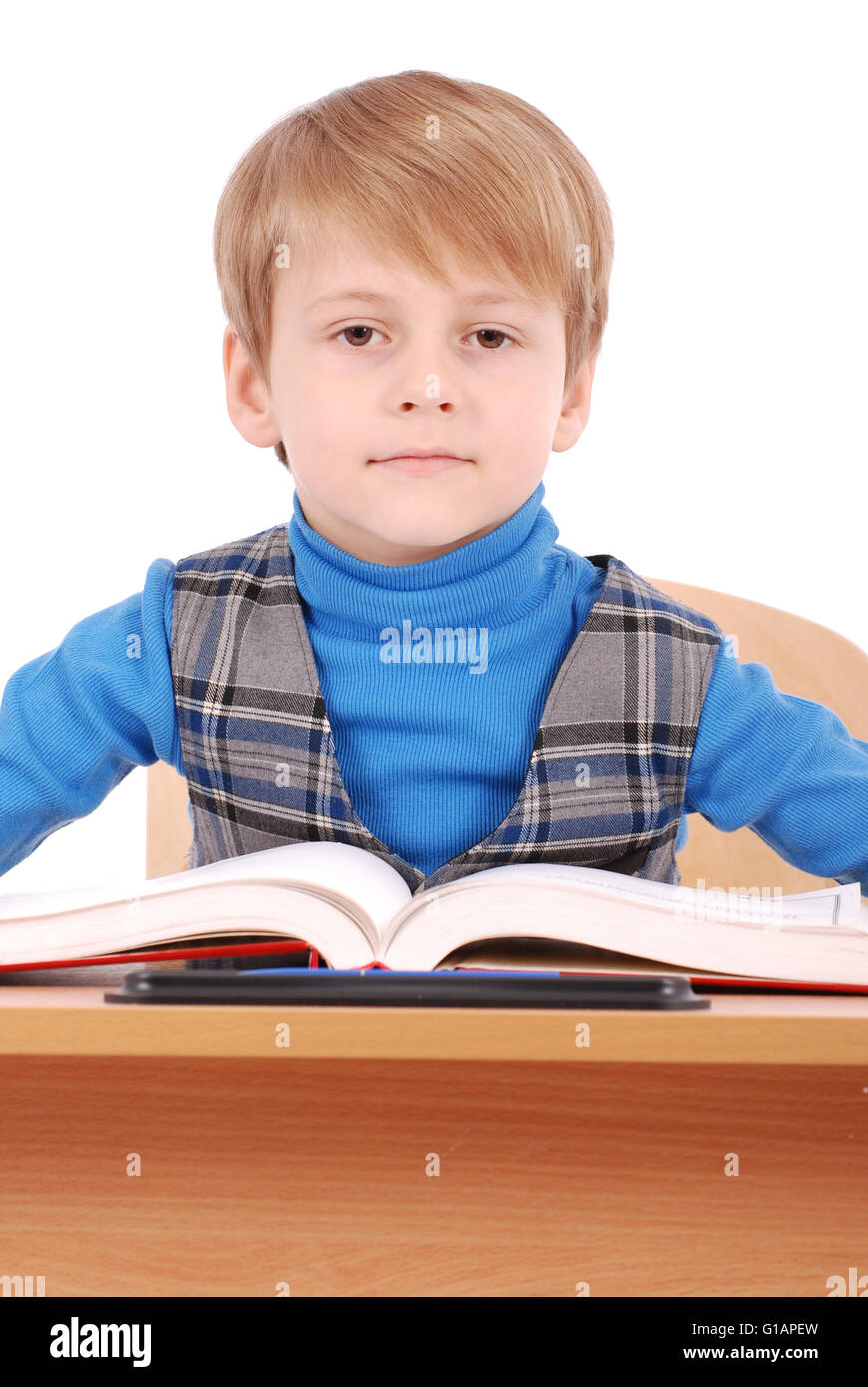 Boy sitting at a school desk isolated on white Stock Photo Alamy