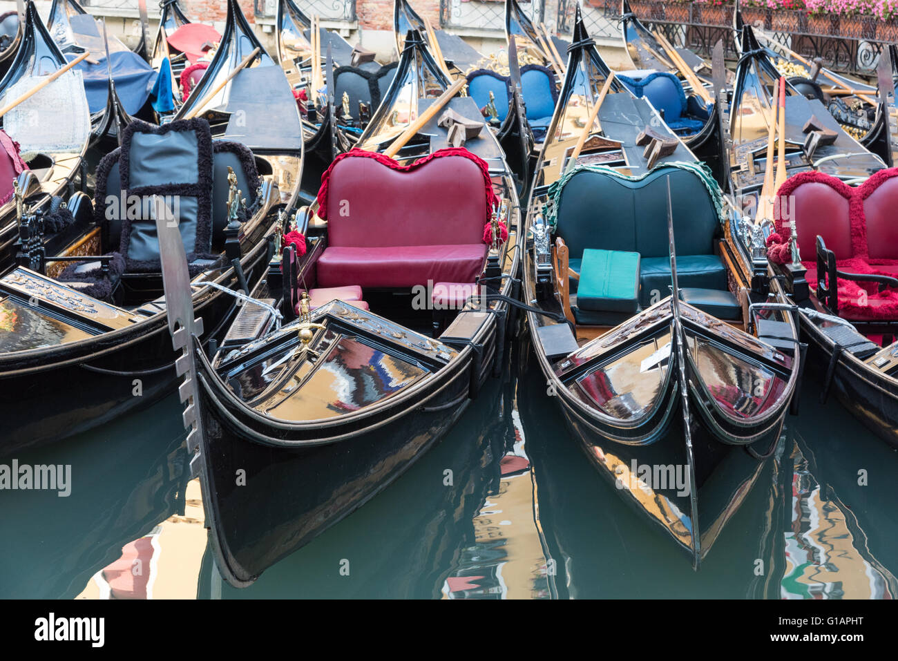 Gondolas, lined up on a canal in Venice.  Italy Stock Photo