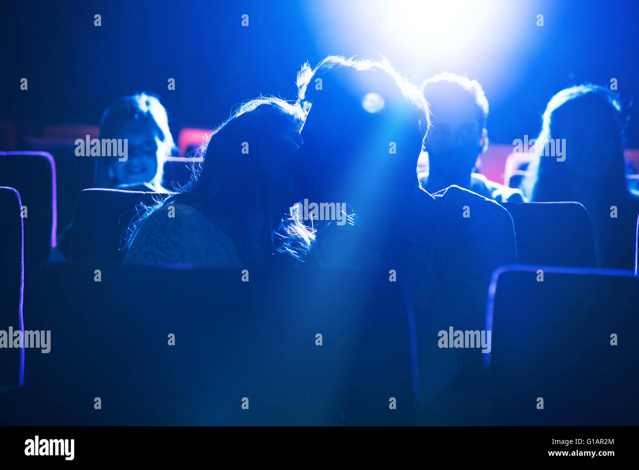 Romantic loving couple kissing at the cinema, love and relationships concept Stock Photo
