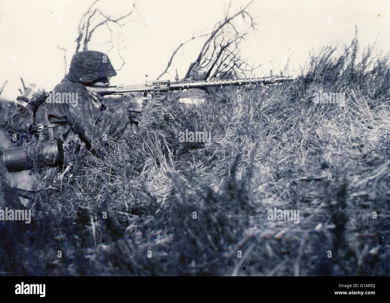 Waffen SS in Camouflage fires an Mg34 Machine Gun in France 1940 Stock Photo