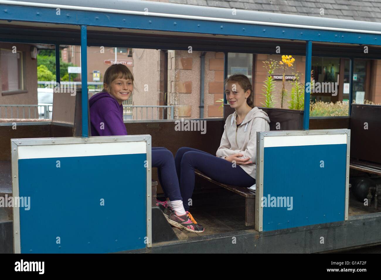Teenage girls on the Ravenglass to Eskdale railway at Ravenglass Station Cumbria Stock Photo