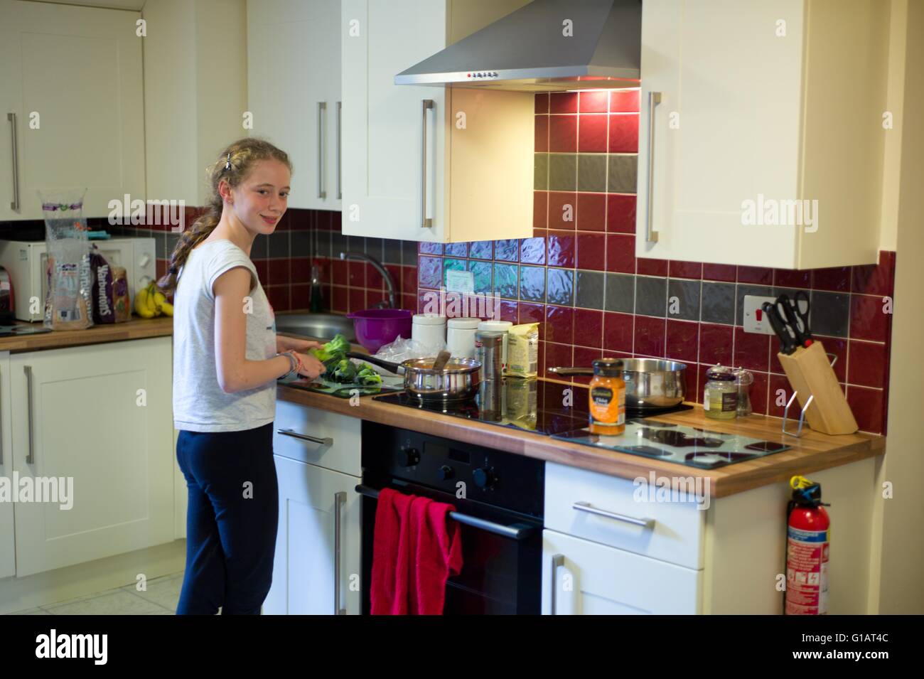 Teenage girl cooking in a kitchen Stock Photo