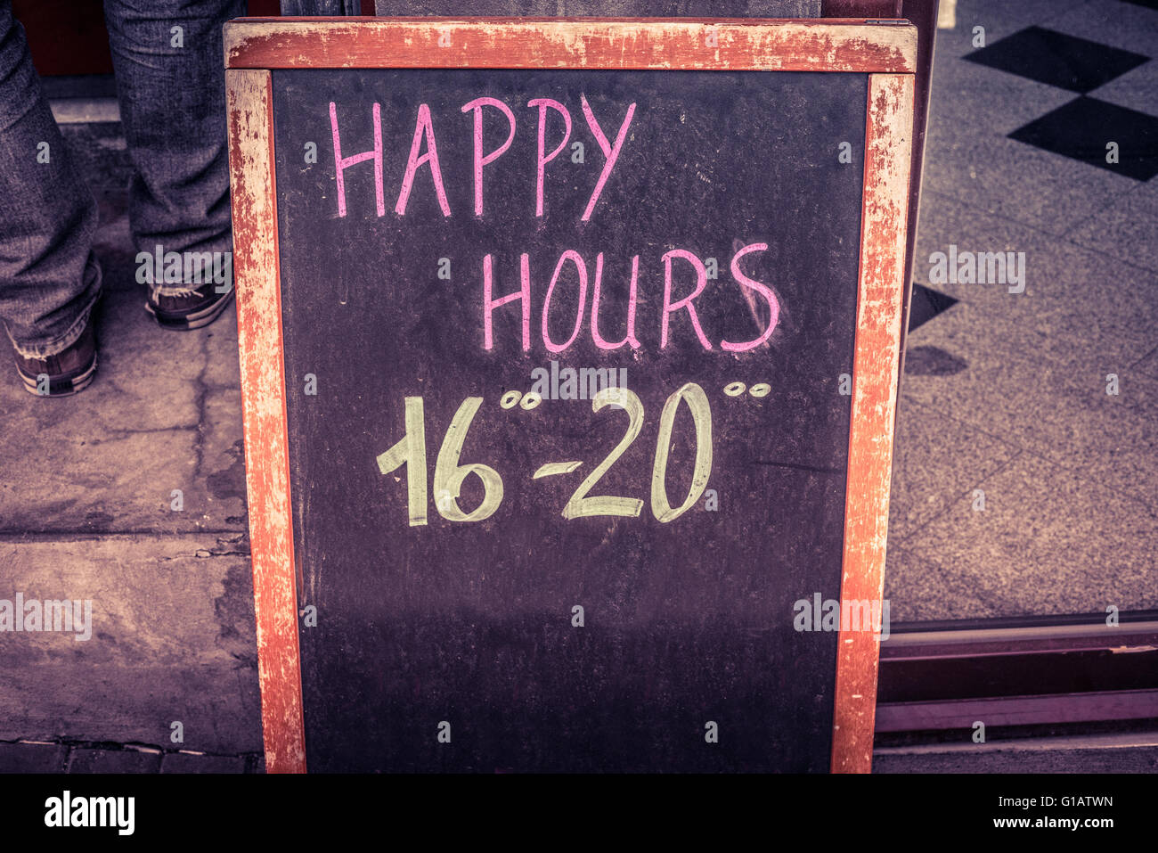 Happy hour board with text written in chalk Stock Photo