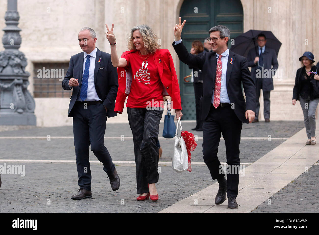 Rome, Italy. 11th May, 2016. Giuseppe Lumia, Monica Cirinna' and Sergio Lo Giudice getting out the Chamber of Deputies with two fingers up, in sign of victory Rome 11th May 2016. Demonstration for Civil Rights while at the Lower Chamber takes place the final vote for the Civil Unions.  Credit:  Insidefoto/Alamy Live News Stock Photo