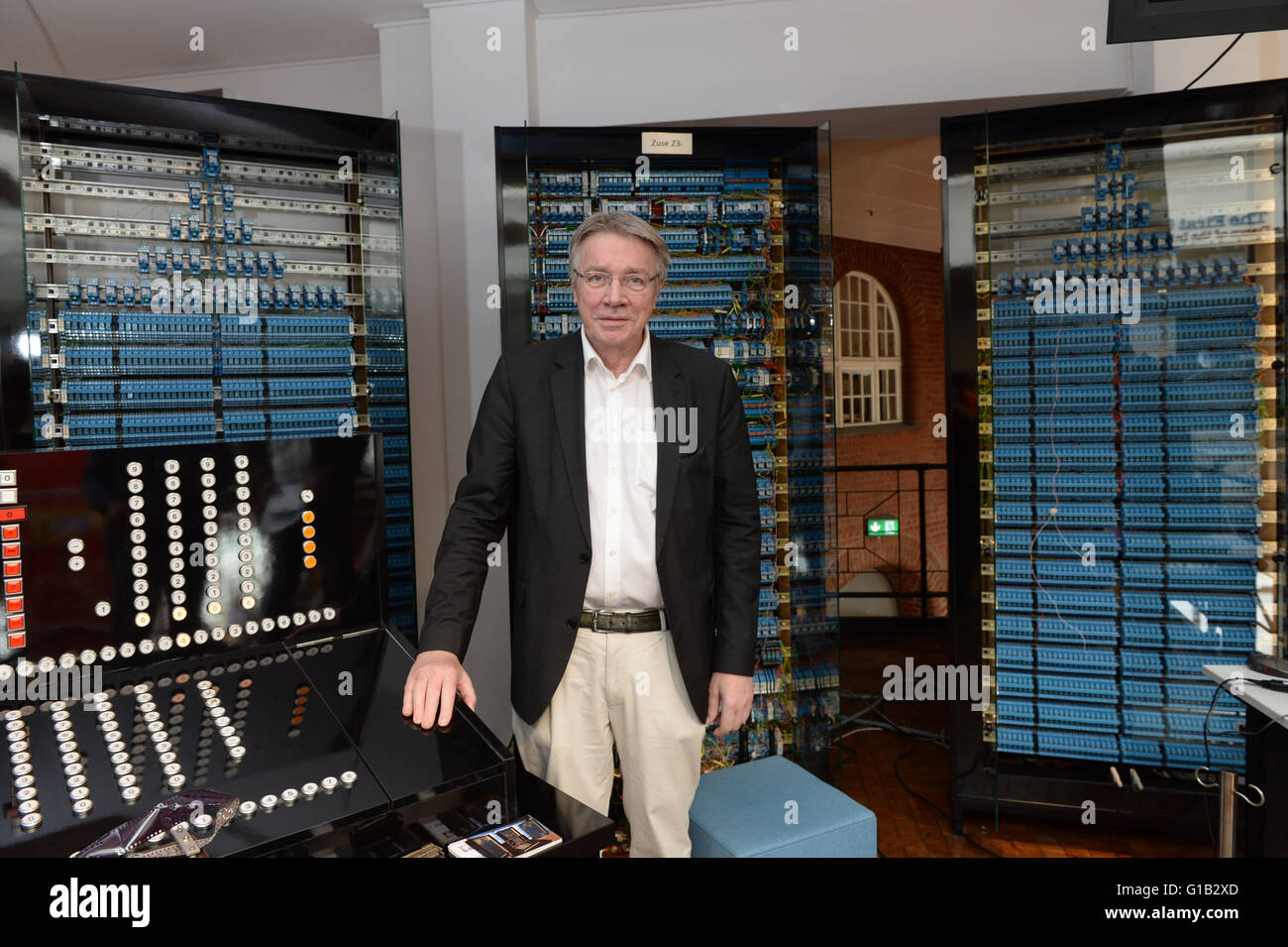 Horst Zuse, son of the computer pioneer Konrad Zuse, poses in front of the replica of the first programable computer in Berlin, Germany, 12 May 2016. The German Museum of Technology is celebrating the anniversary '75 Years of the Z3 Computer from Konrad Zuse.' Today computers can computer around a billion times faster than the Z3. Photo: PAUL ZINKEN/dpa Stock Photo