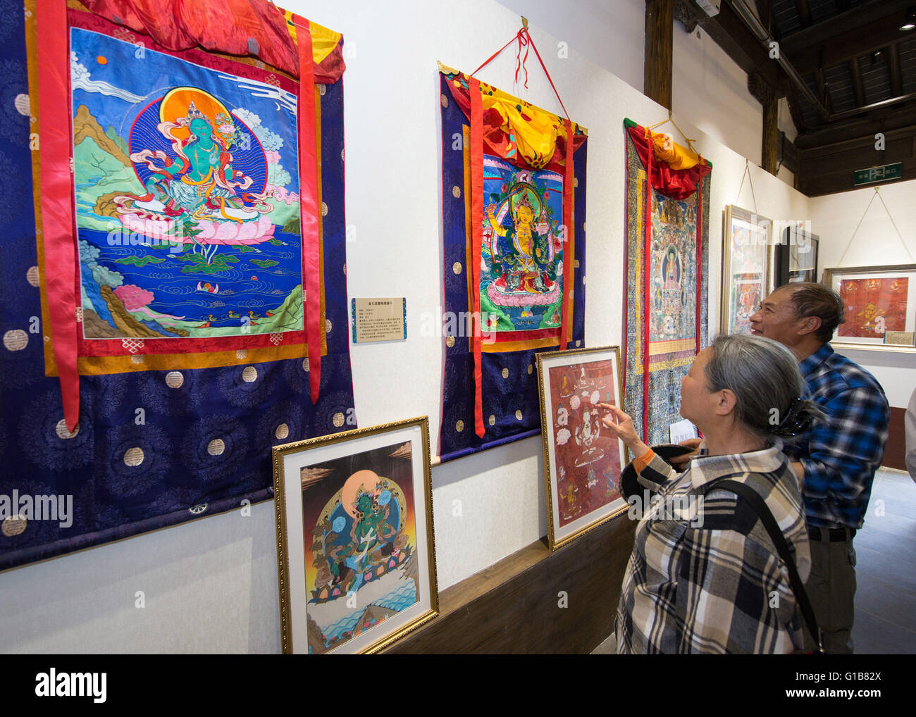 Nanjing, Nanjing, CHN. 12th May, 2016. Nanjing, China - May 12 2016: (EDITORIAL USE ONLY. CHINA OUT ) Thangka Exhibition from Gongka County Mozhu Yibet in Nanjing's Yu Garden. A thangka, variously spelt as tangka, thanka or tanka (Nepali pronunciation: [?t??a?ka]; Tibetan: ?????; Nepal Bhasa: ????) is a Tibetan Buddhist painting on cotton, or silk appliquÂ¨Â¦, usually depicting a Buddhist deity, scene, or mandala. Thangkas are traditionally kept unframed and rolled up when not on display, mounted on a textile backing somewhat in the style of Chinese scroll paintings, with a further silk cover Stock Photo
