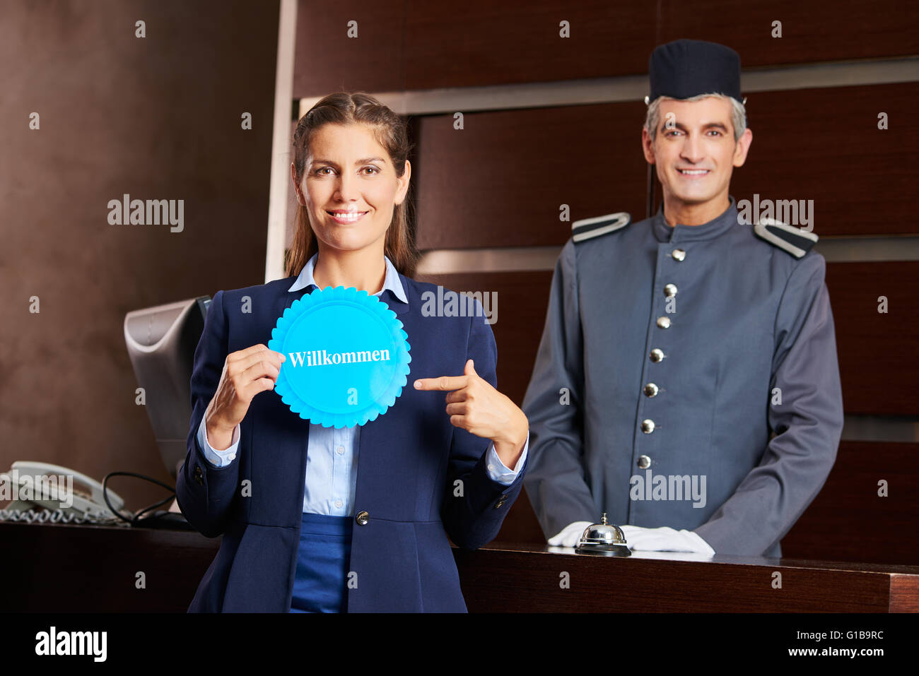 Woman pointing to German sign saying "Willkommen" at the