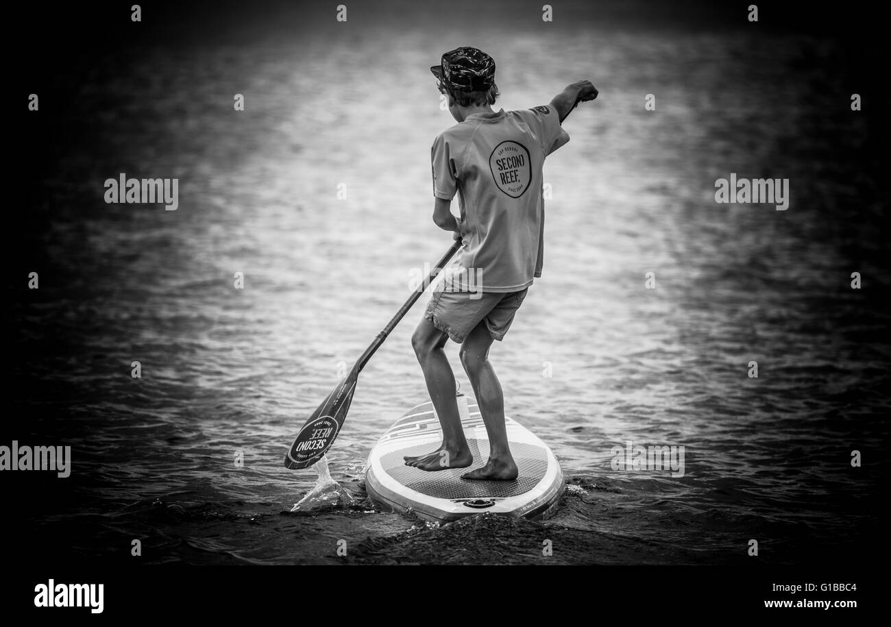boy doing Stand up paddle on the seaside Stock Photo