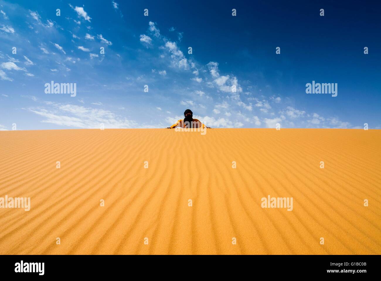 Libya, Sahara Desert, Fezzan, Erg Murzuq, Tuareg or Touareg on top of a dune Stock Photo