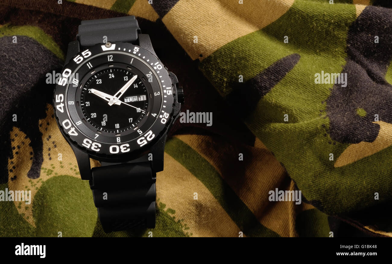 Tritium military watch on camouflage clothing Stock Photo