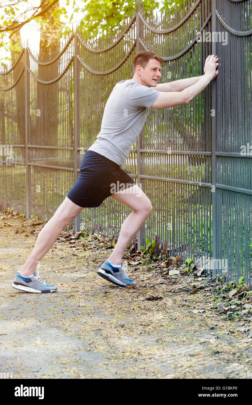 Man athletic stretching outdoor hi-res stock photography and images - Alamy