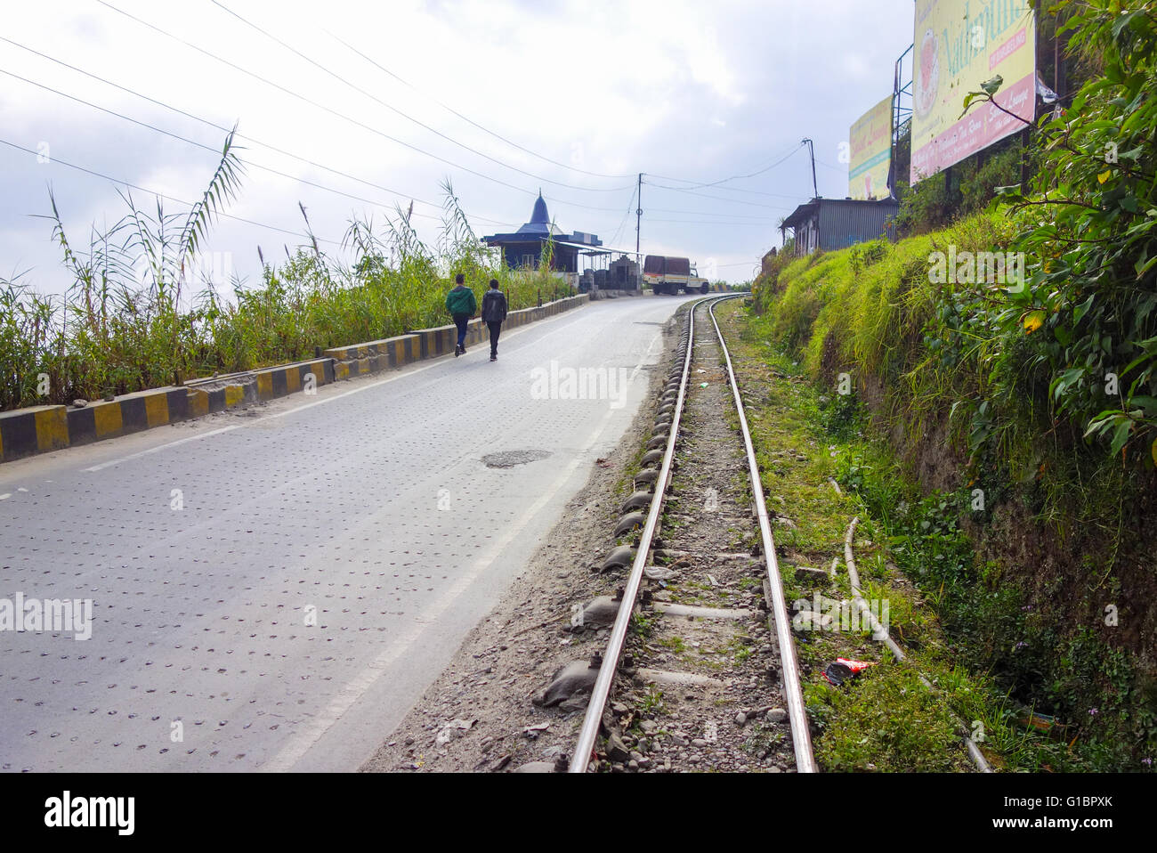 Darjeeling Himalayan Railway Toy Train track alongside National Highway 55 near Sonada, West Bengal, India Stock Photo