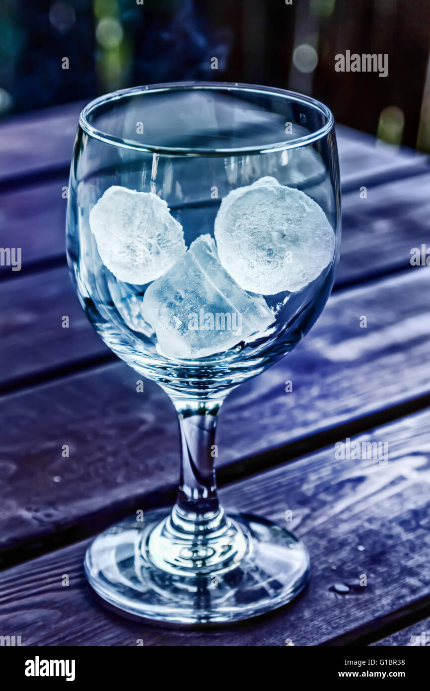 Fresh ice in empty glass at blue tones Stock Photo