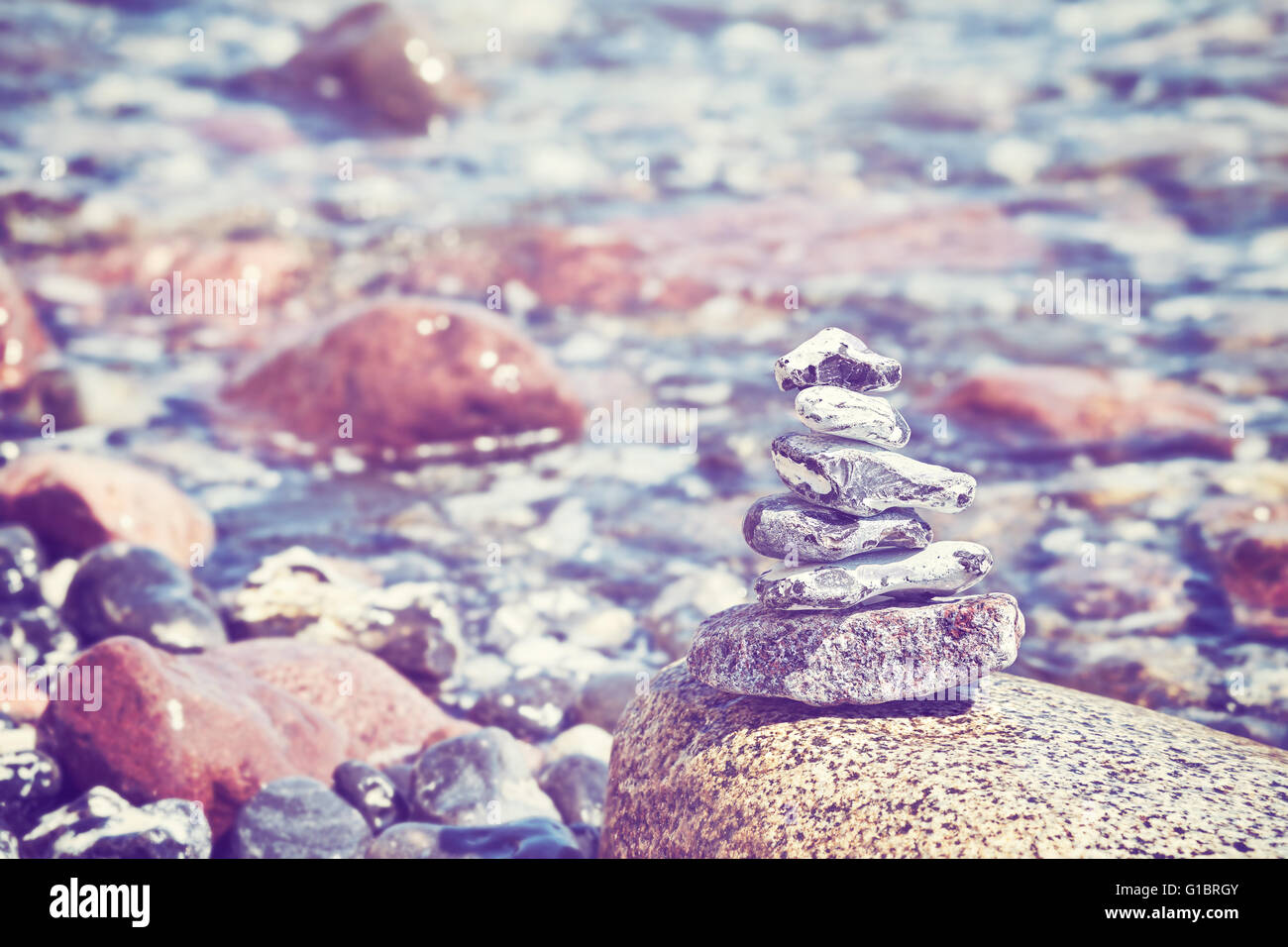 Vintage toned image of stones on beach, nature, Zen and harmony concept background. Stock Photo