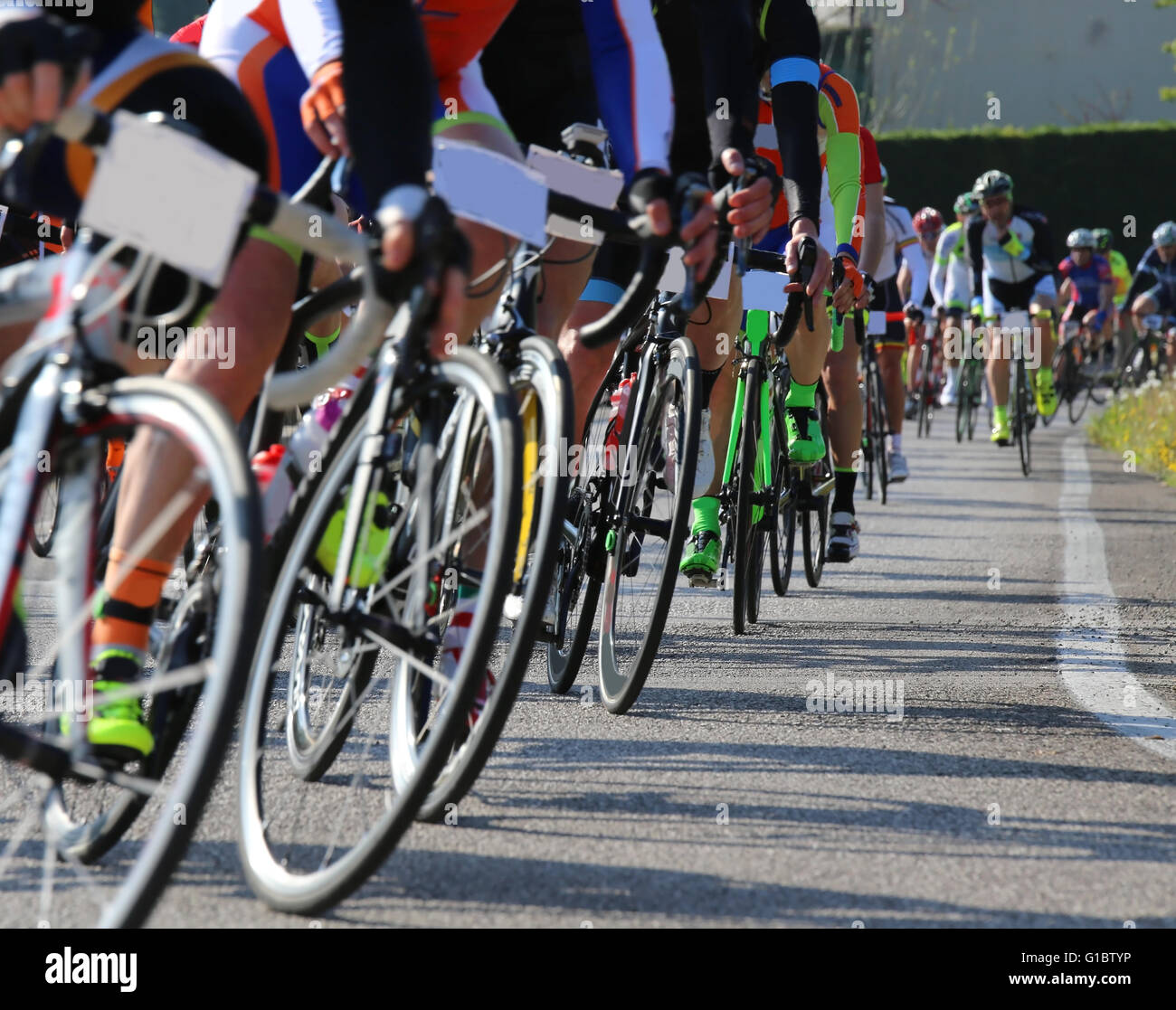 many race bike and professional cyclists during the cycling race on the road Stock Photo