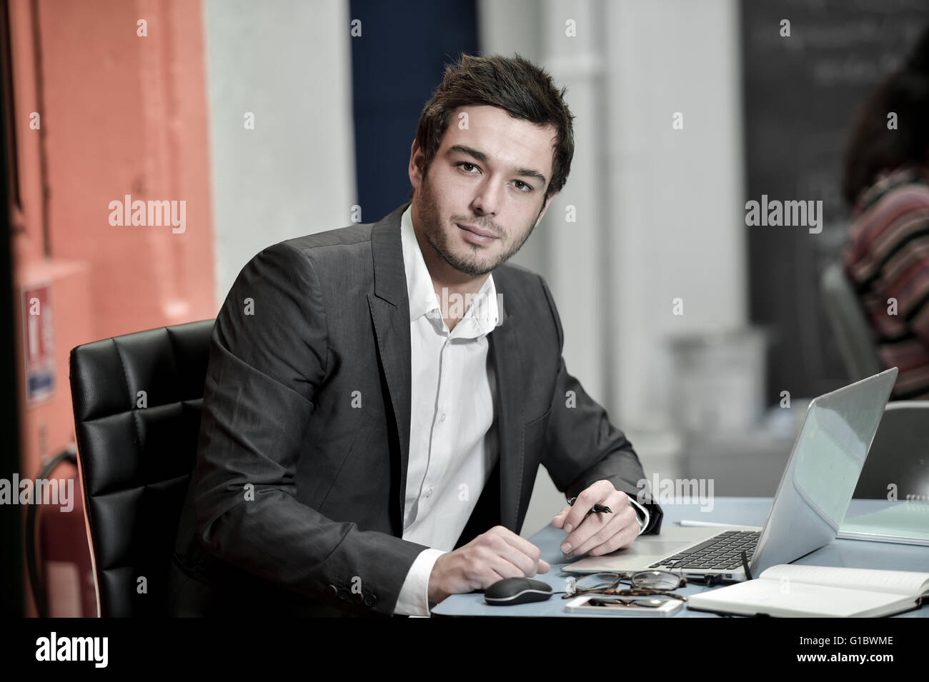 Portrait of smiling Businessman posing in coworking office Stock Photo ...