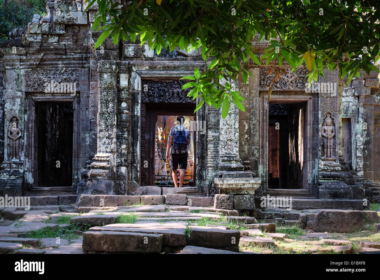 A tourist makes his way through the ancient ruins of Wat Phou near Champasak, Laos. Stock Photo