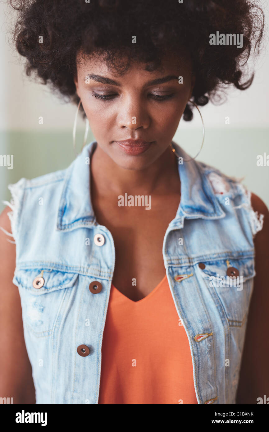 Close up portrait of a pensive african woman. Stylish young female