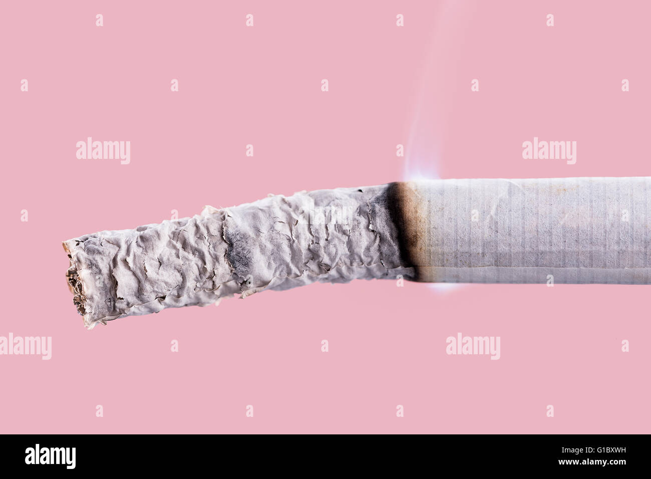 Cigarette burning on pink background, quit smoking concept Stock Photo