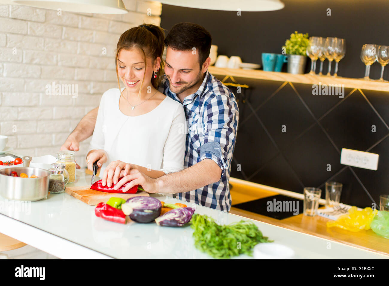 Loving couple preparing healthy food in modern kitchen Stock Photo