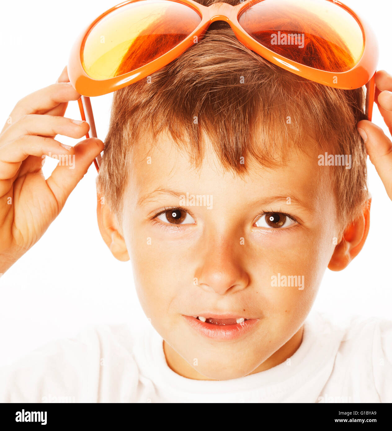little cute boy in orange sunglasses pointing isolated close up part of