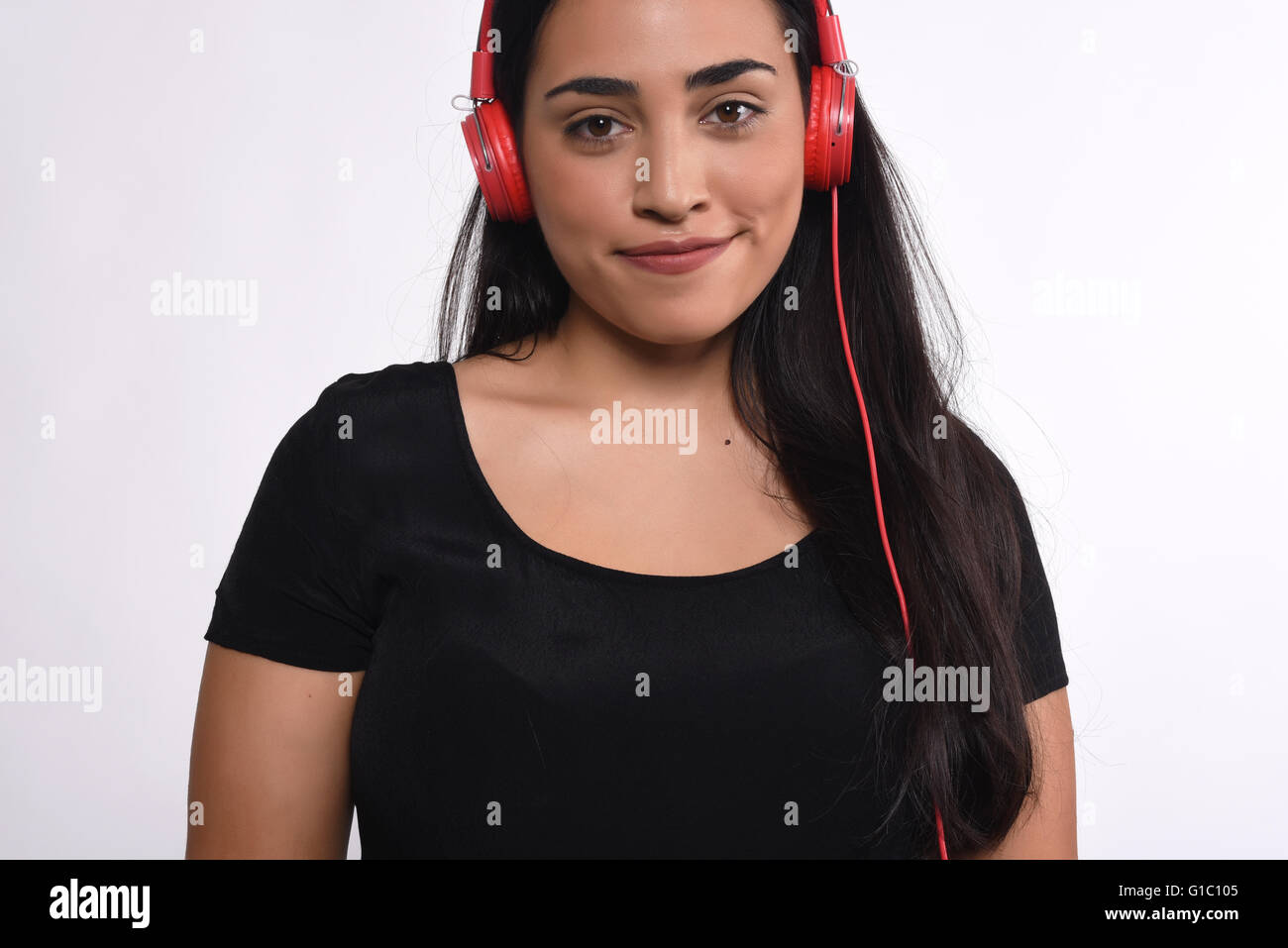 Portrait of young beautiful woman listening to music indoor. Isolated ...