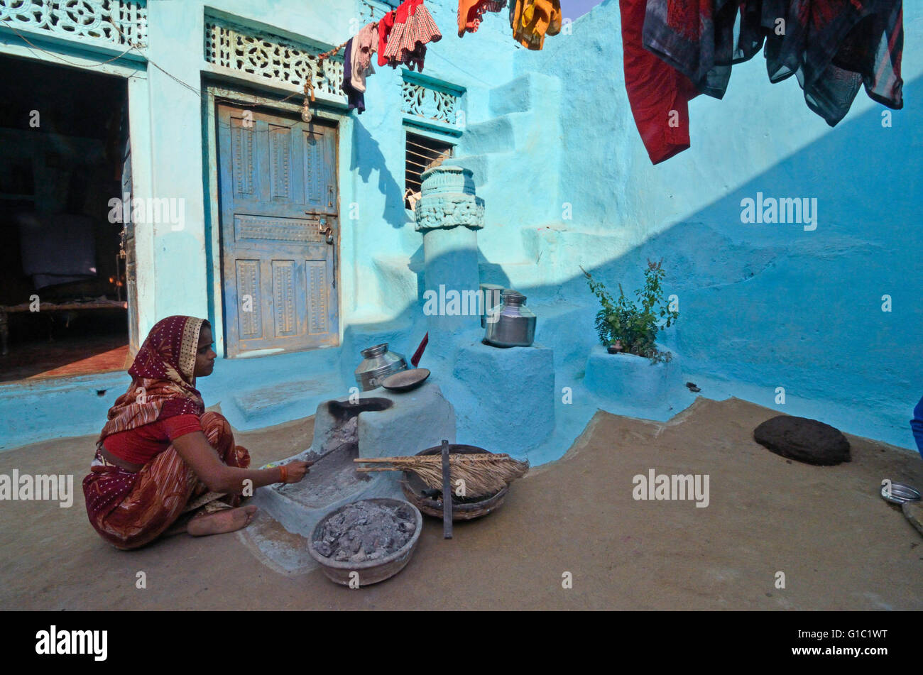 Woman working in the home made mud oven in a village house, Khajuraho village, Madhya Pradesh, India Stock Photo