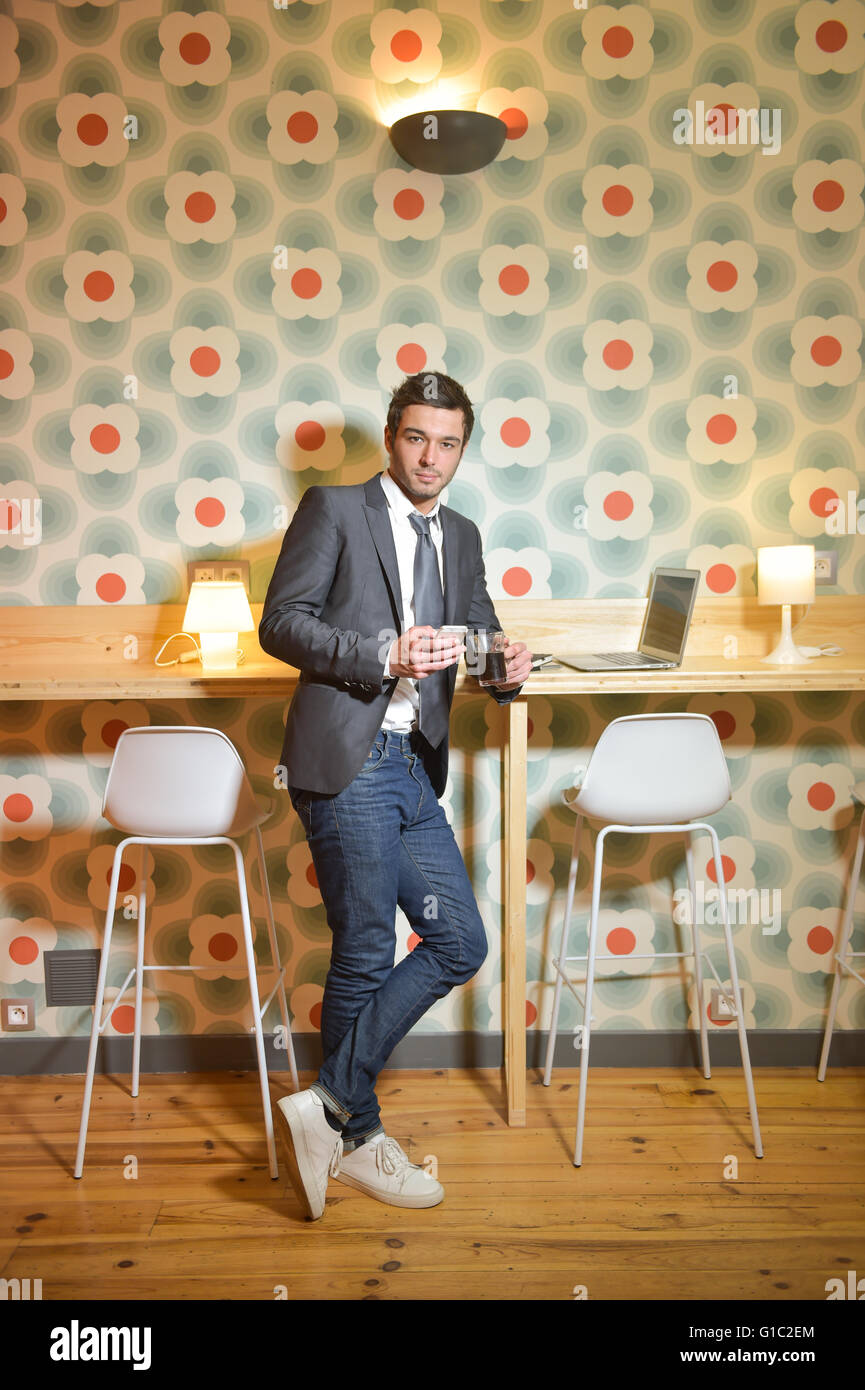 Handsome business man in restaurant drinking coffee Stock Photo