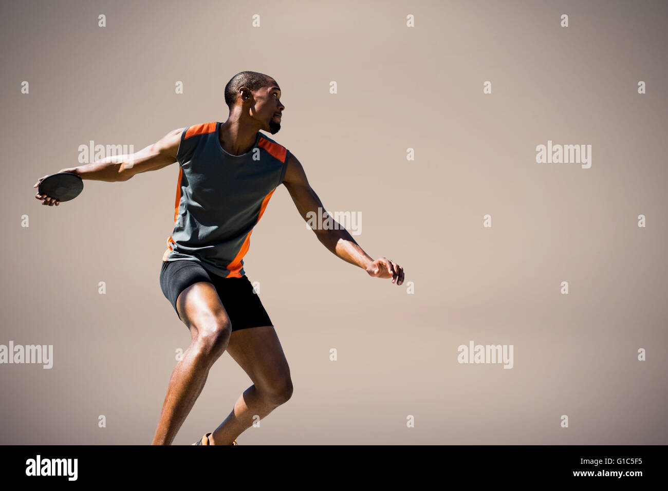 Composite image of athlete man throwing a discus Stock Photo