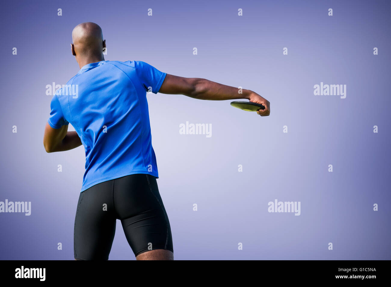 Composite image of rear view of discus pitcher Stock Photo - Alamy