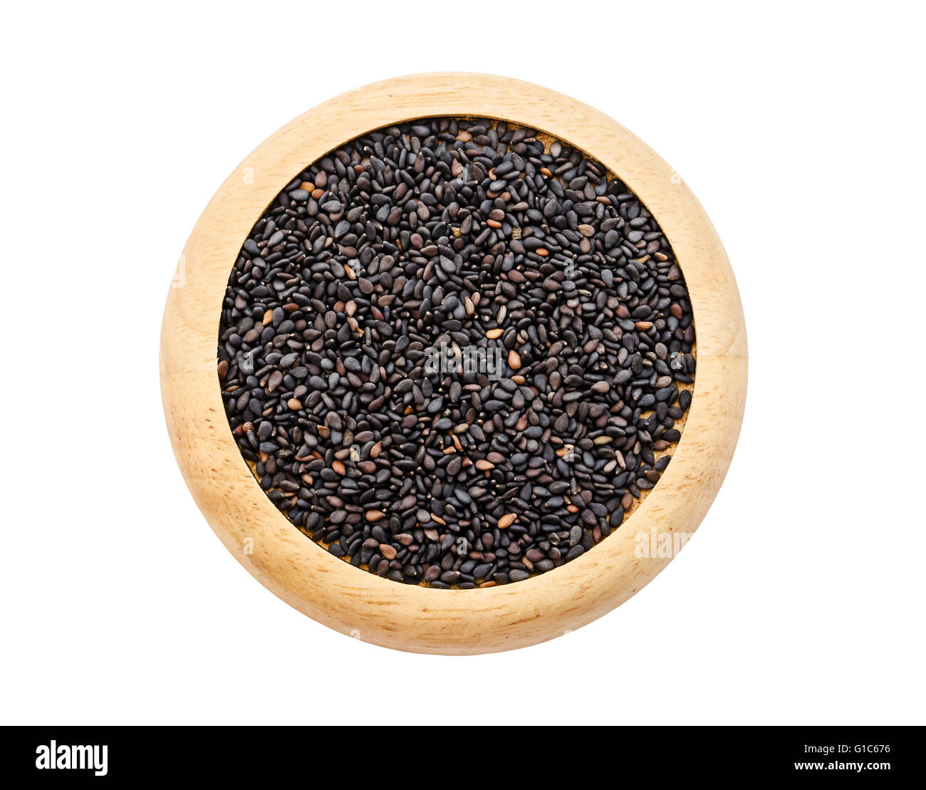 Pile of black sesame seeds in wooden dish isolated on white background, Save clipping path. Stock Photo