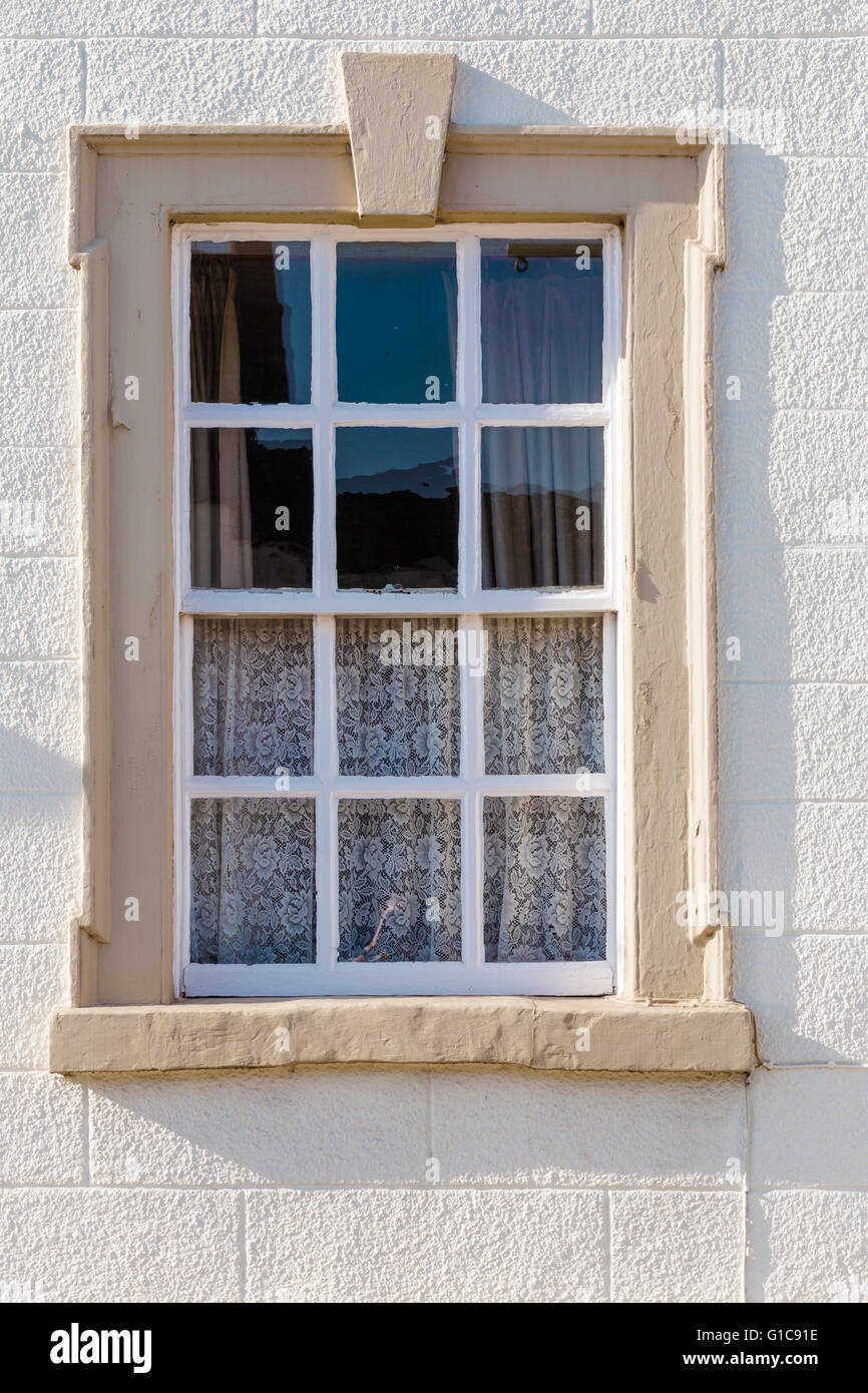 A Georgian sash window in classical stone frame of a building on the High Street, Chipping Sodbury, near Bristol. Stock Photo