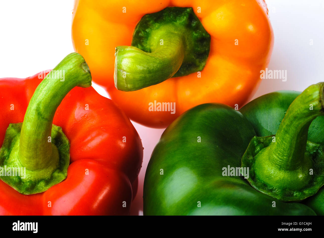 Bell Pepper Capsicum red yellow orange green. Group of  3 peppers. Stock Photo