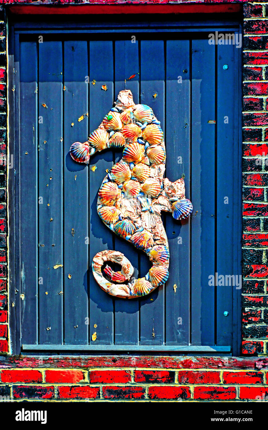 North Shields funny mussel and scallop shell seahorse on blue door Stock Photo