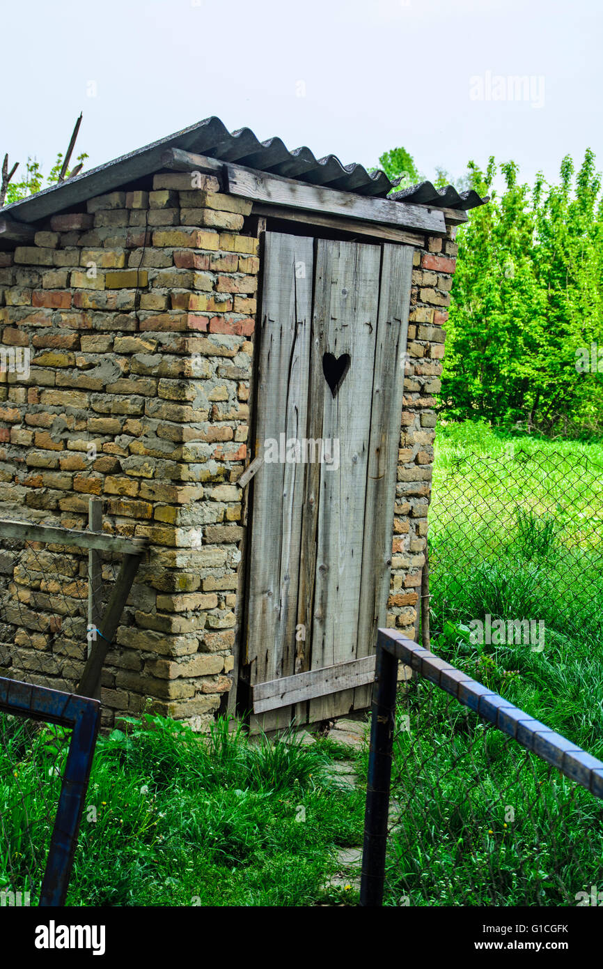 Old rural toilet in an extra yard. Stock Photo