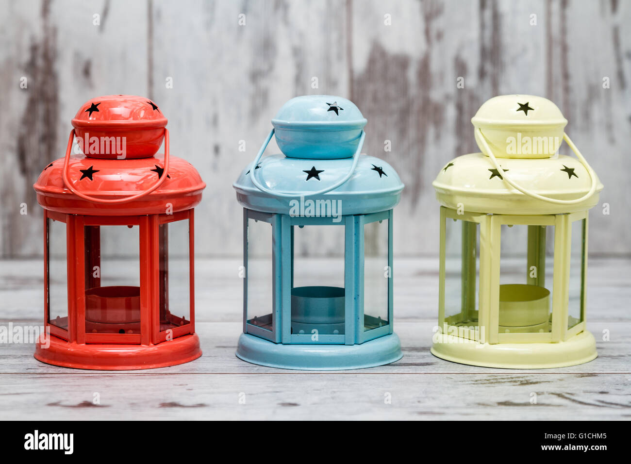 Colorful candle holders on white wooden background Stock Photo Alamy