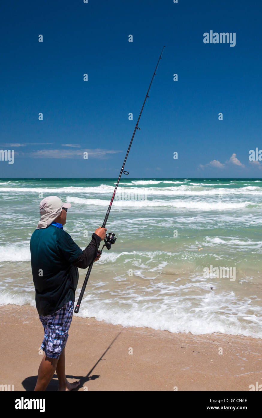 Titusville, Florida - A fisherman in the Atlantic Ocean surf at Canaveral National Seashore. Stock Photo