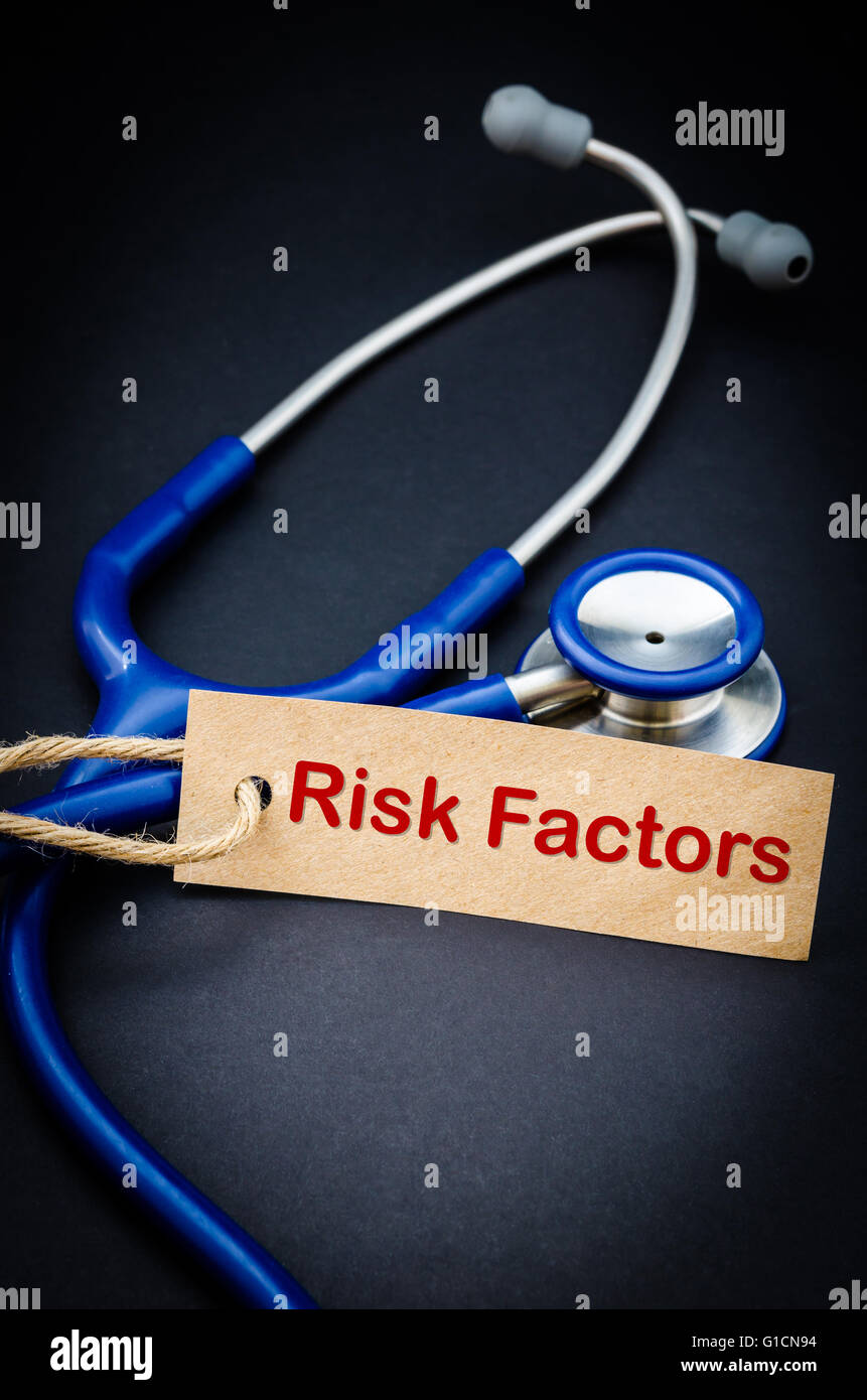 Risk factor word in paper tag with stethoscope on black background - health concept. Medical conceptual Stock Photo