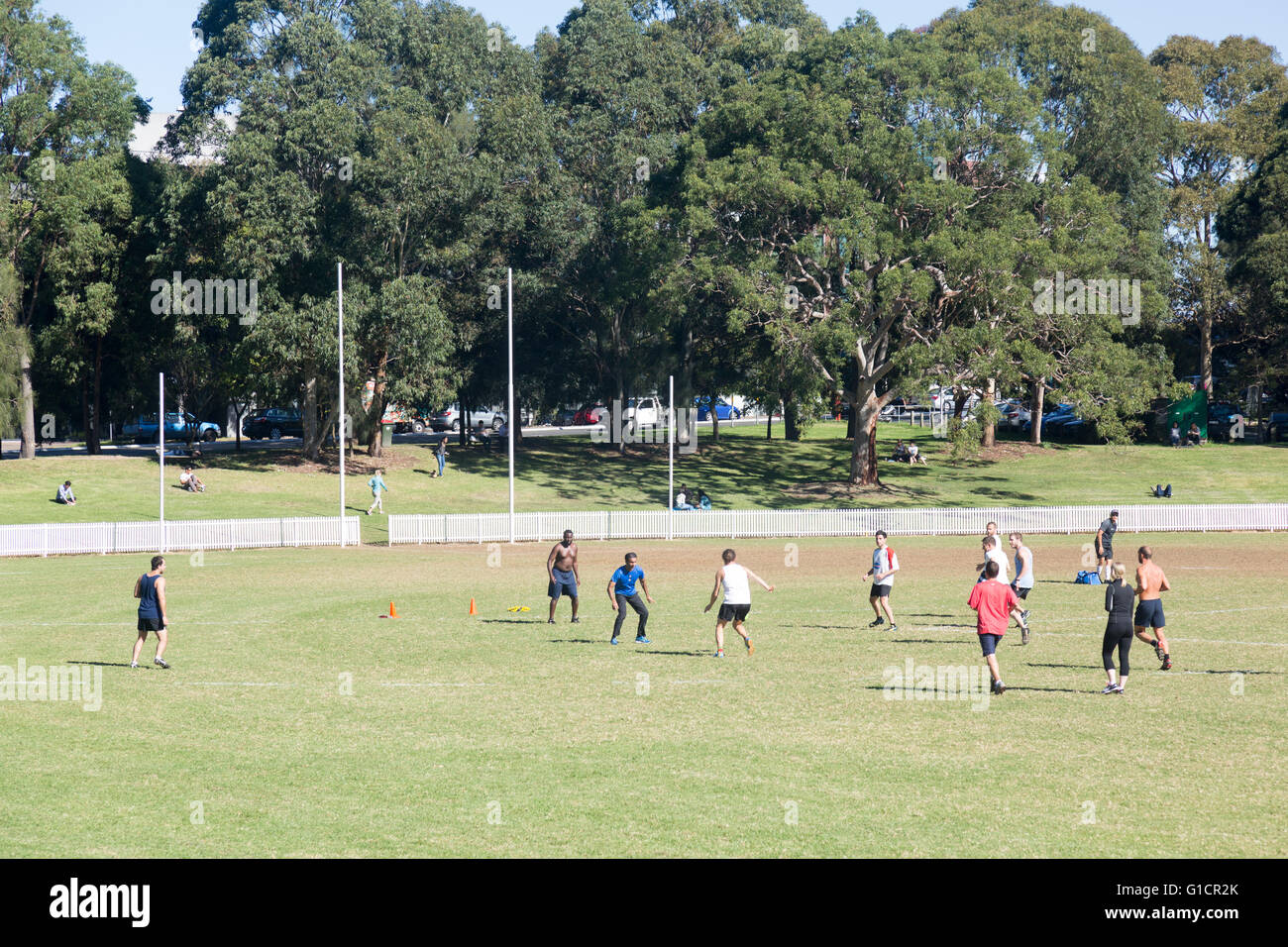 Sydney sports oval in st leonards with a group of men and women playing football soccer, australia Stock Photo