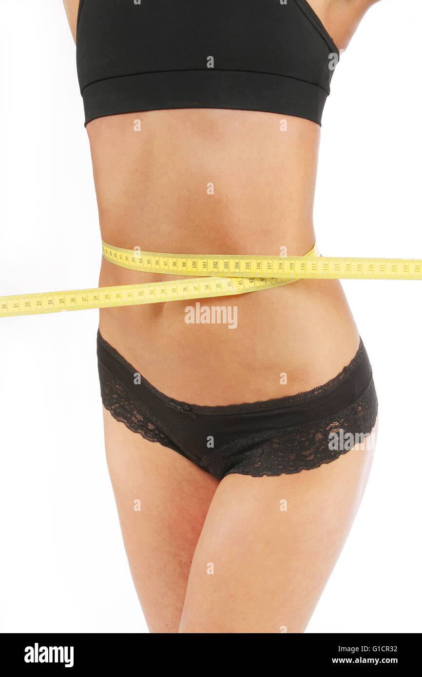 Girl measuring her waist with tape measure Stock Photo Alamy