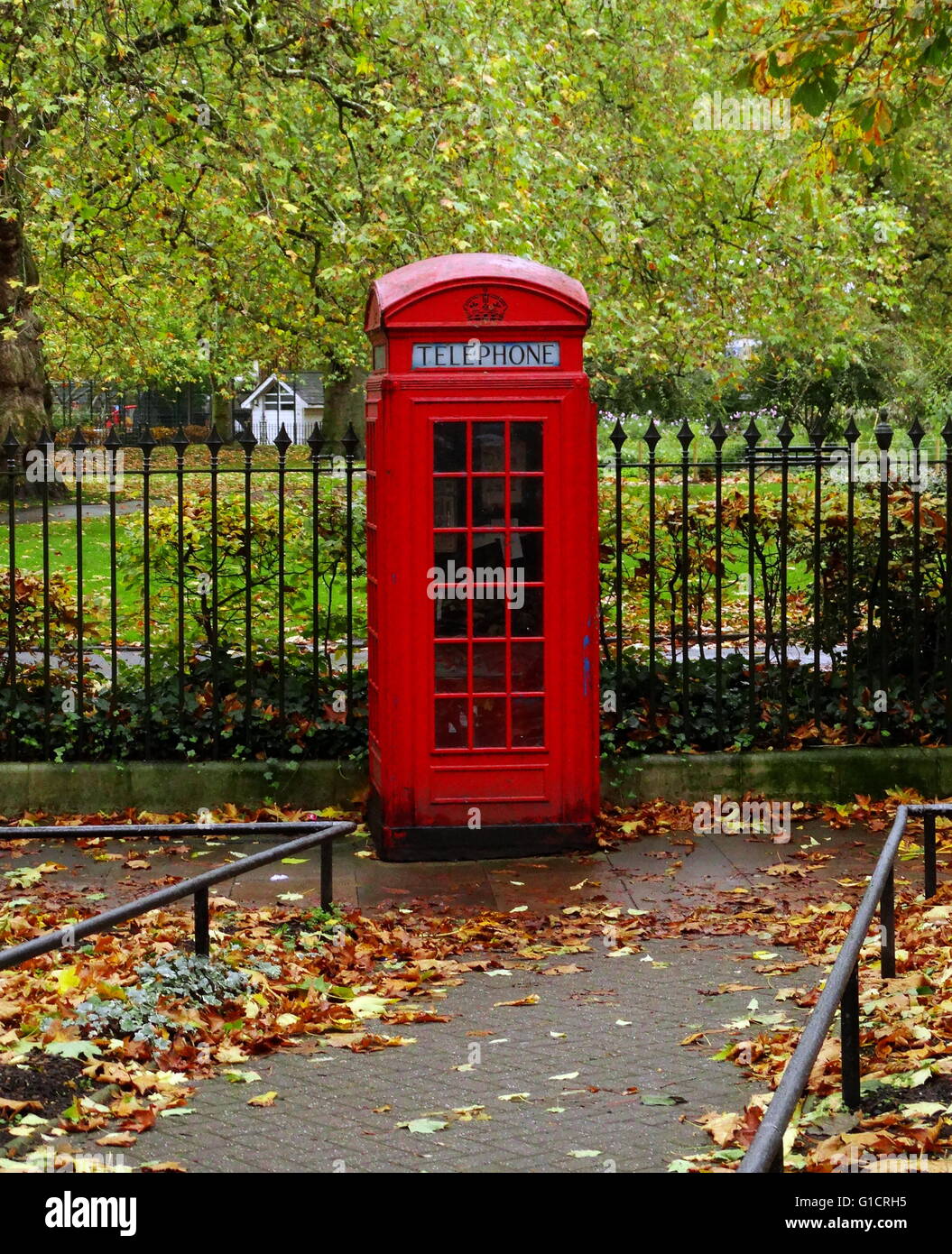 The red telephone box; a telephone kiosk for a public telephone in the United Kingdom. designed by Sir Giles Gilbert Scott in 1926 Stock Photo