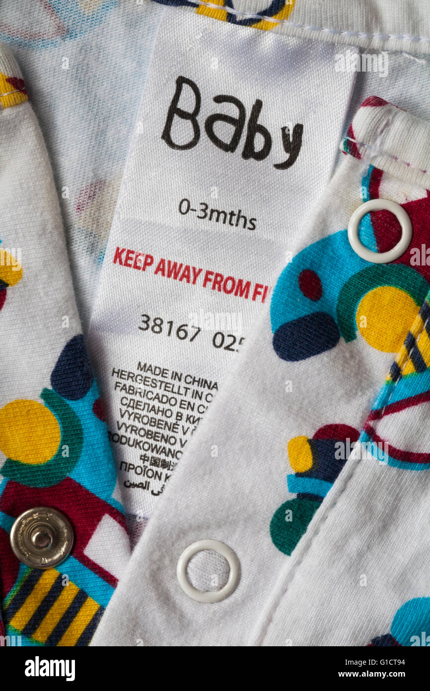 Keep away from fire label in Baby baby grow garment for 0-3 mths made in China - sold in the UK United Kingdom, Great Britain Stock Photo
