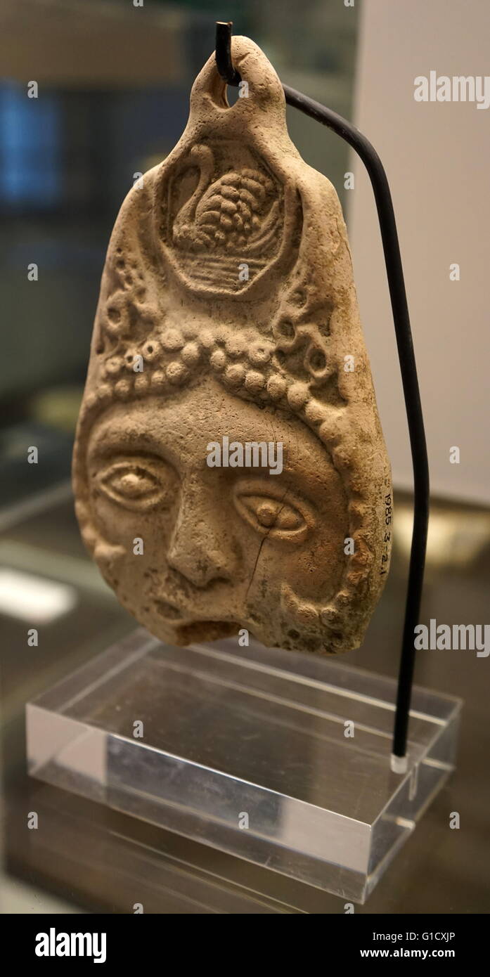 Double-sided plaque with face, swan motif in head-dress and hole for suspension. Dated 13th Century Stock Photo