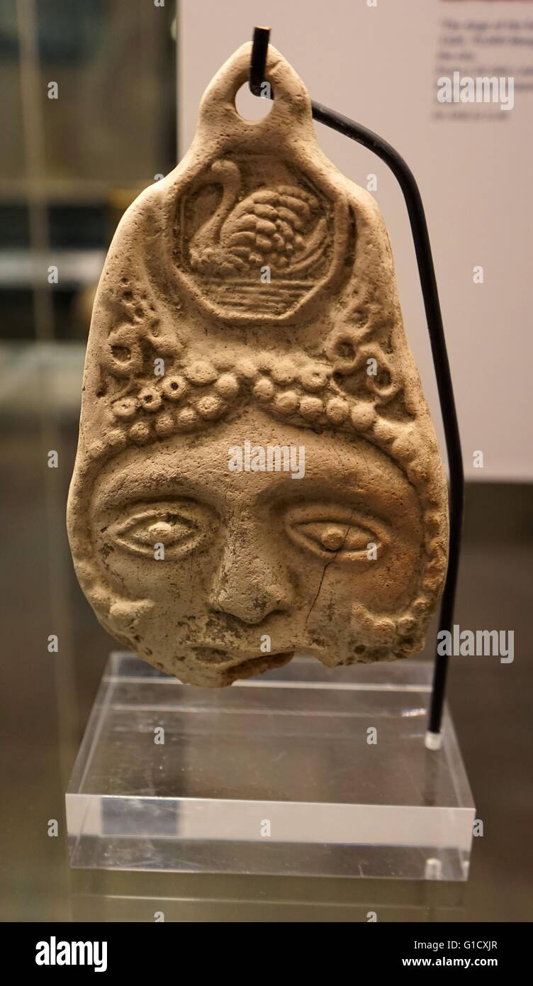 Double-sided plaque with face, swan motif in head-dress and hole for suspension. Dated 13th Century Stock Photo