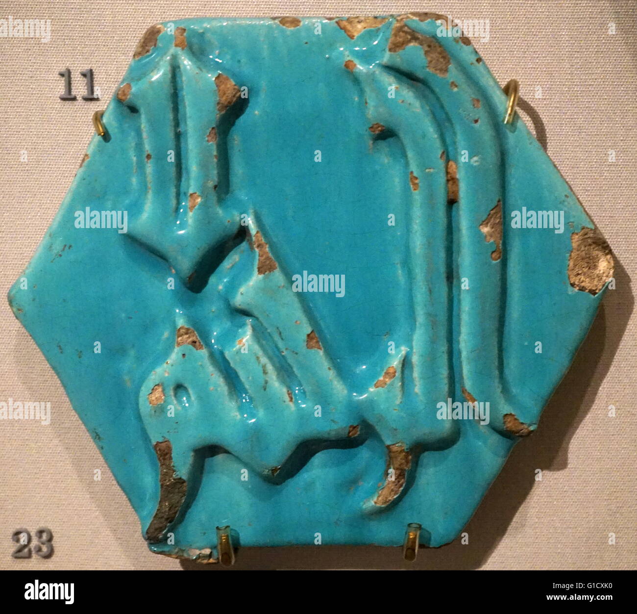 Calligraphic relief tile with turquoise glaze, from Iran. Dated 13th Century Stock Photo