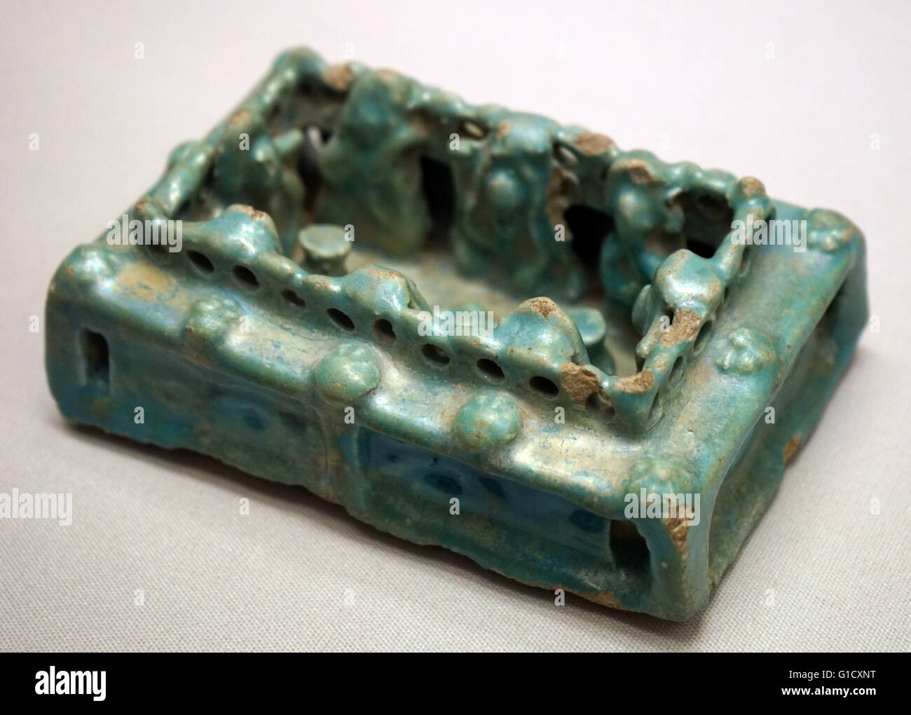 Ceramic model of a house with figures seated in a courtyard. Dated 13th Century Stock Photo