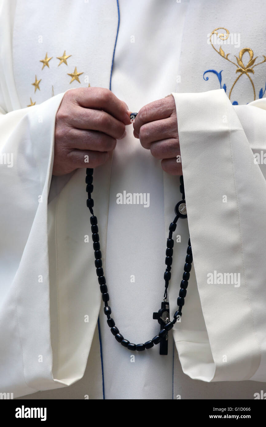 Hand-carved Roman Catholic rosary beads. Priest praying The Mystery of the Holy Rosary. La Roche-sur-Foron. France. Stock Photo